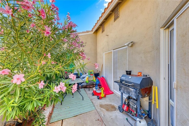 view of patio featuring a grill