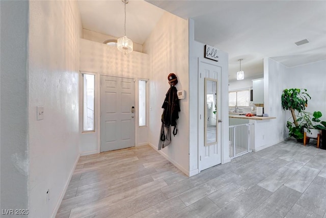 entryway featuring an inviting chandelier