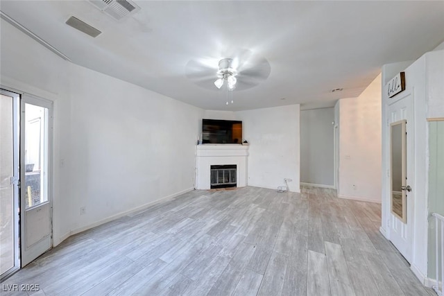 unfurnished living room featuring ceiling fan and light hardwood / wood-style floors