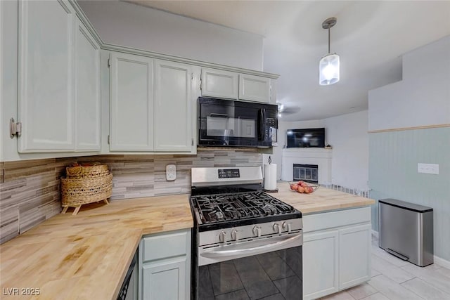 kitchen with stainless steel range with gas cooktop, pendant lighting, wooden counters, white cabinets, and light tile patterned flooring