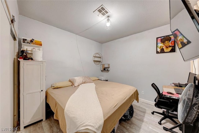 bedroom featuring light hardwood / wood-style floors