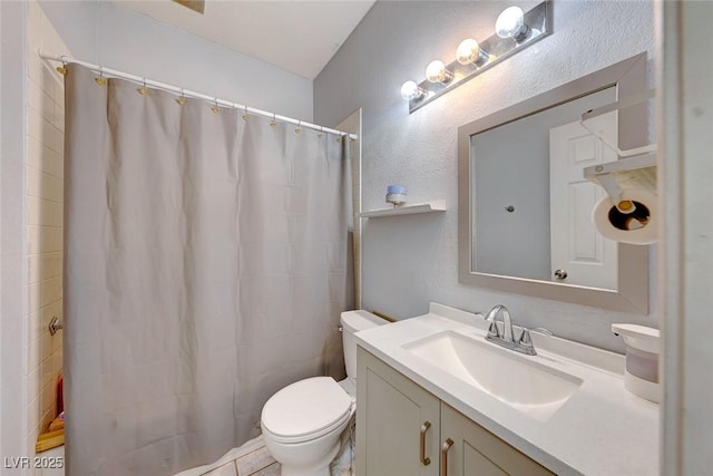 bathroom featuring toilet, vanity, and a shower with curtain