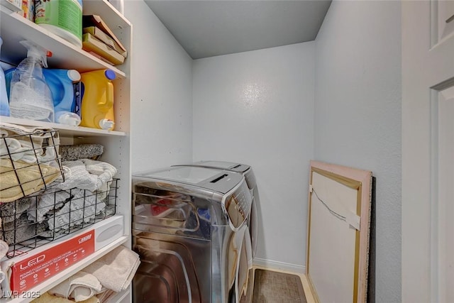 clothes washing area featuring wood-type flooring and independent washer and dryer