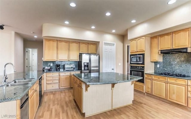 kitchen with sink, a center island, dark stone countertops, decorative backsplash, and black appliances