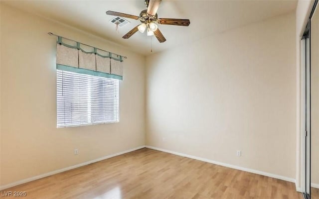 spare room with ceiling fan and wood-type flooring