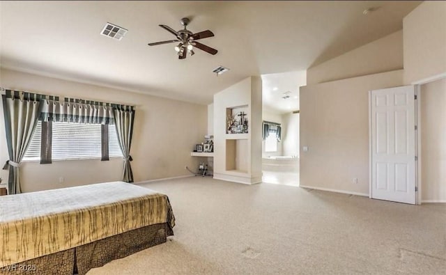 bedroom featuring vaulted ceiling, ensuite bath, ceiling fan, and carpet flooring