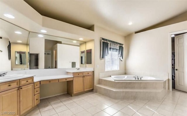 bathroom with a relaxing tiled tub, tile patterned floors, lofted ceiling, and vanity