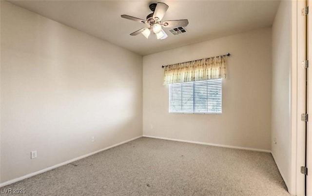 unfurnished room with light colored carpet and ceiling fan