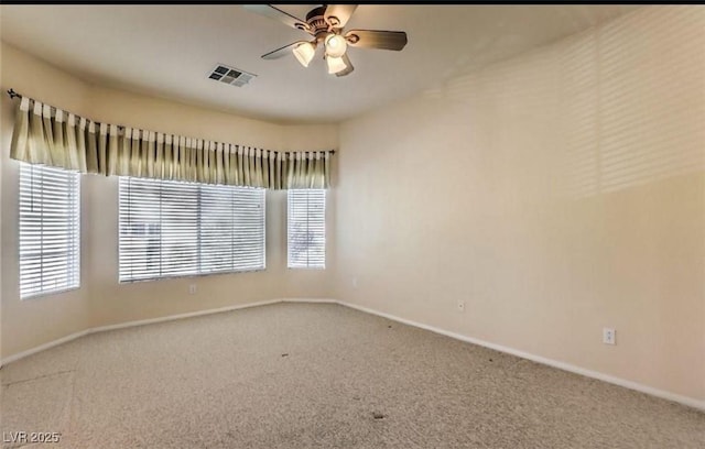 carpeted empty room featuring ceiling fan