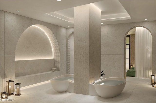 bathroom with a bidet and a tray ceiling