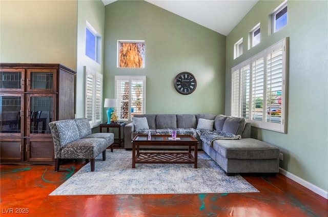 living room with high vaulted ceiling