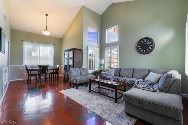 living room featuring lofted ceiling and plenty of natural light