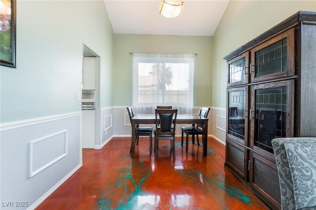 dining space featuring vaulted ceiling