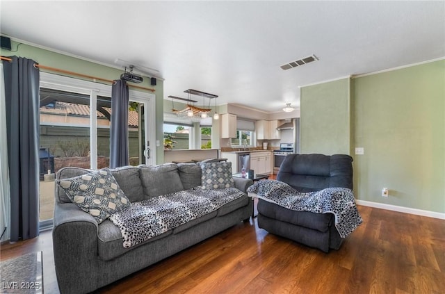 living room with crown molding and hardwood / wood-style flooring