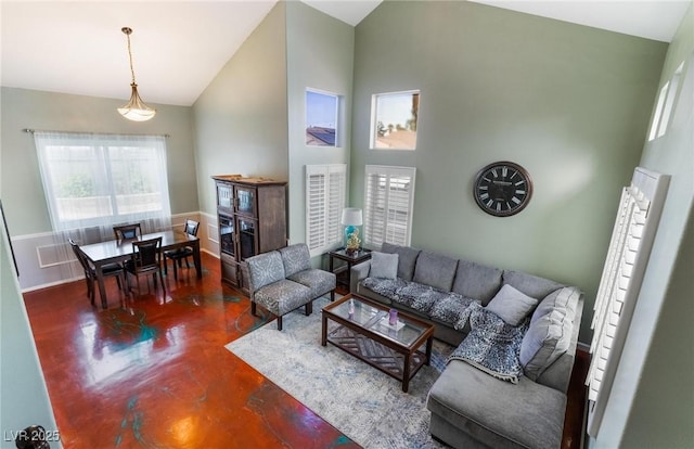 living room with high vaulted ceiling