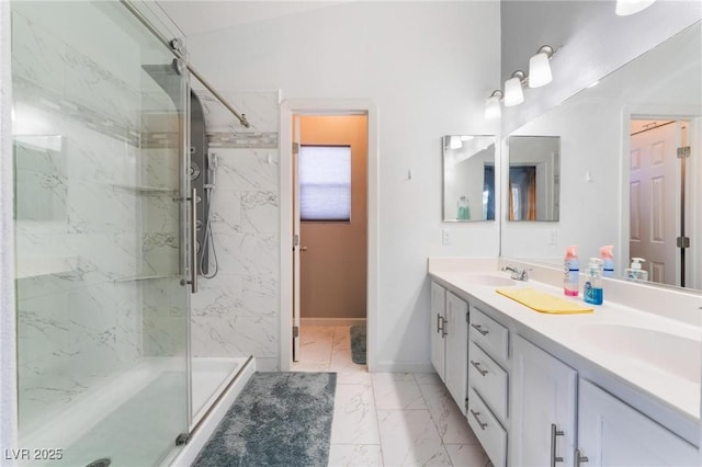 bathroom with a shower with door and vanity