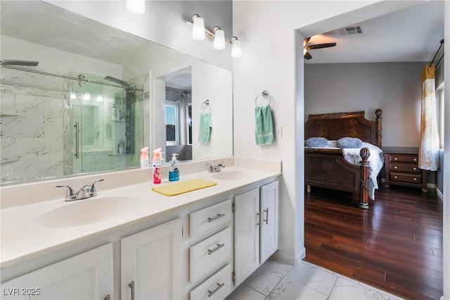 bathroom with an enclosed shower, vanity, and ceiling fan