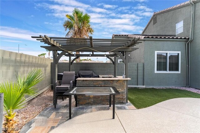 view of patio / terrace with exterior bar and a pergola