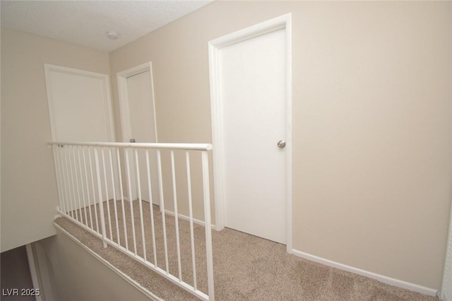 corridor featuring light colored carpet