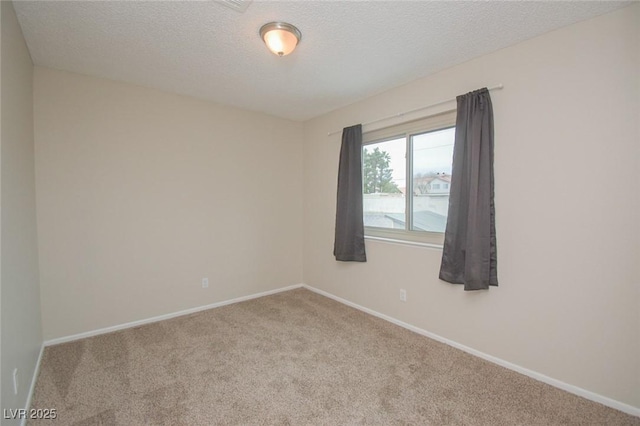 carpeted spare room with a textured ceiling