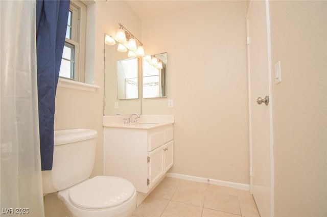 bathroom with tile patterned flooring, vanity, and toilet