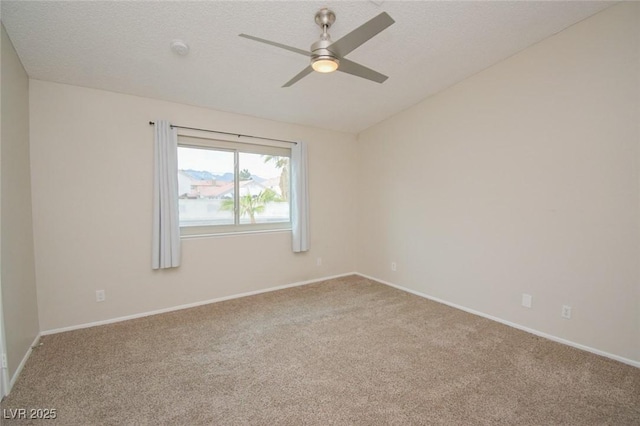 empty room featuring ceiling fan, carpet floors, and a textured ceiling