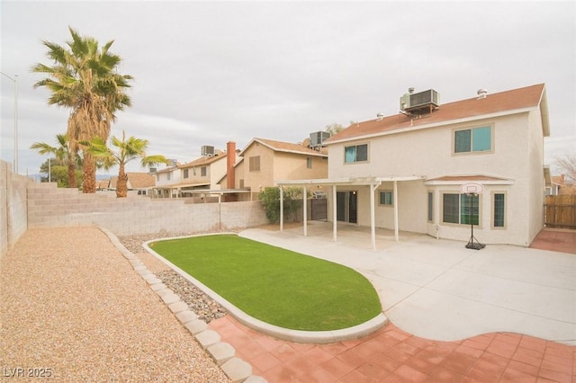 back of property featuring central AC unit and a patio