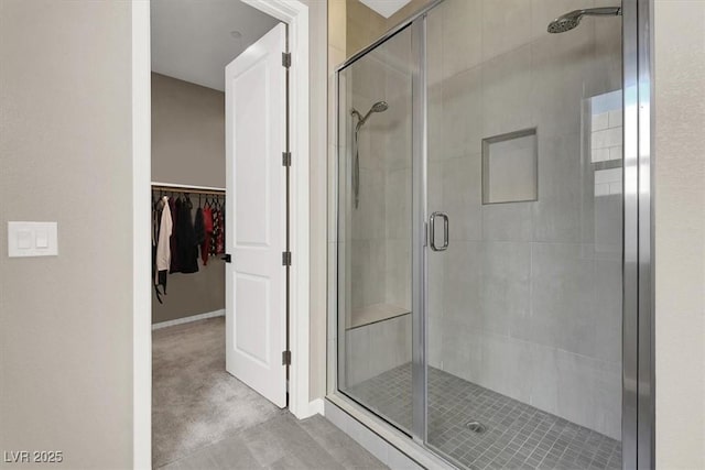 bathroom with a shower with door