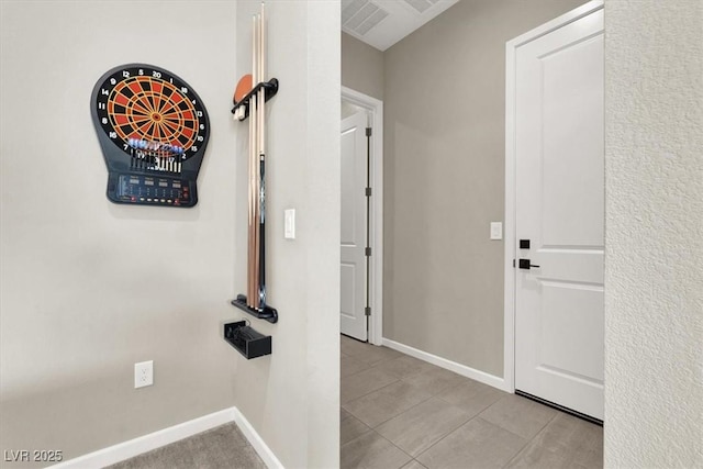 hall featuring light tile patterned floors