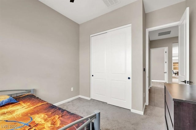 bedroom featuring a closet and light carpet