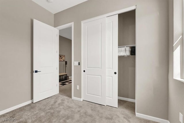 unfurnished bedroom with a closet and light carpet