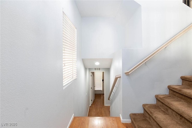 stairs with hardwood / wood-style floors