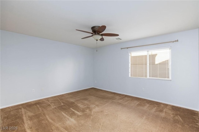 empty room featuring ceiling fan and carpet floors