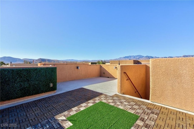 view of yard featuring a mountain view and a patio