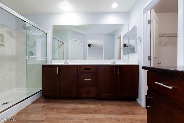 bathroom with vanity, wood-type flooring, ceiling fan, and walk in shower