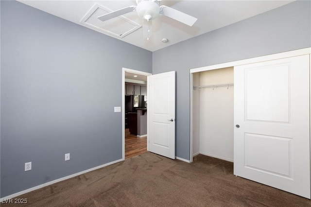 unfurnished bedroom with dark carpet, a closet, and ceiling fan