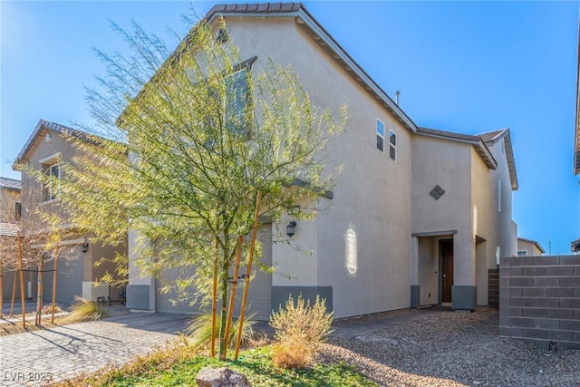 back of house featuring a garage