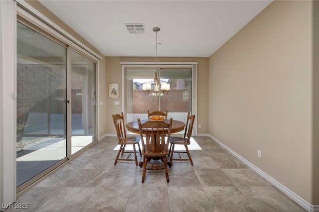 dining area featuring an inviting chandelier