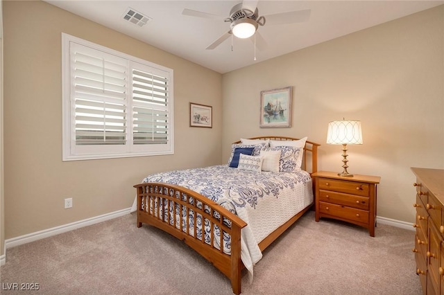 bedroom with ceiling fan and light colored carpet