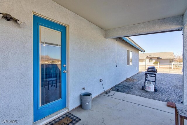 property entrance featuring a patio area