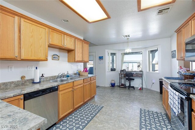 kitchen with hanging light fixtures, appliances with stainless steel finishes, and sink