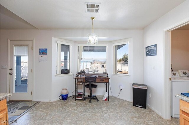 home office with washing machine and dryer and a chandelier