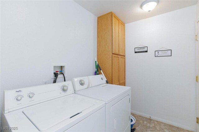 laundry room with cabinets and washer and clothes dryer