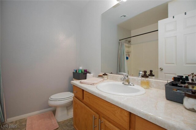 bathroom featuring toilet, vanity, tile patterned floors, and curtained shower