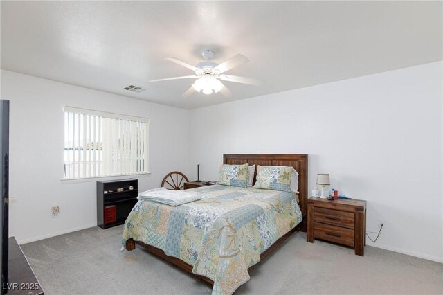 bedroom with ceiling fan and light carpet