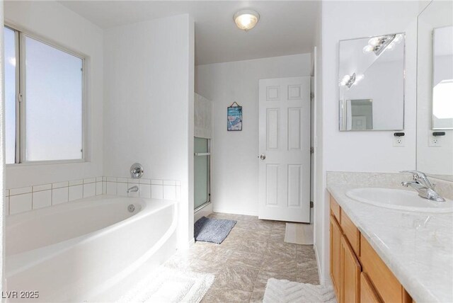 bathroom with separate shower and tub and vanity