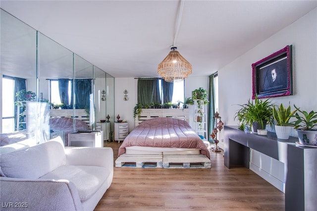 bedroom featuring hardwood / wood-style flooring and an inviting chandelier