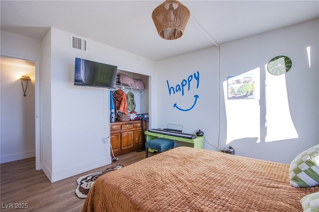 bedroom with hardwood / wood-style flooring