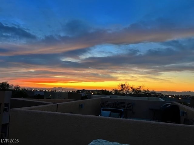 yard at dusk featuring a balcony