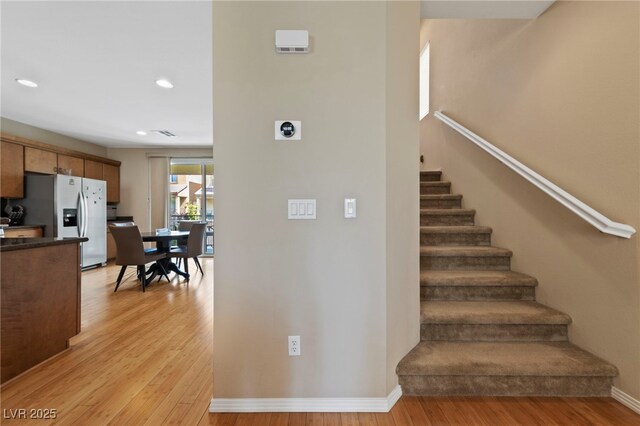 stairs featuring hardwood / wood-style floors